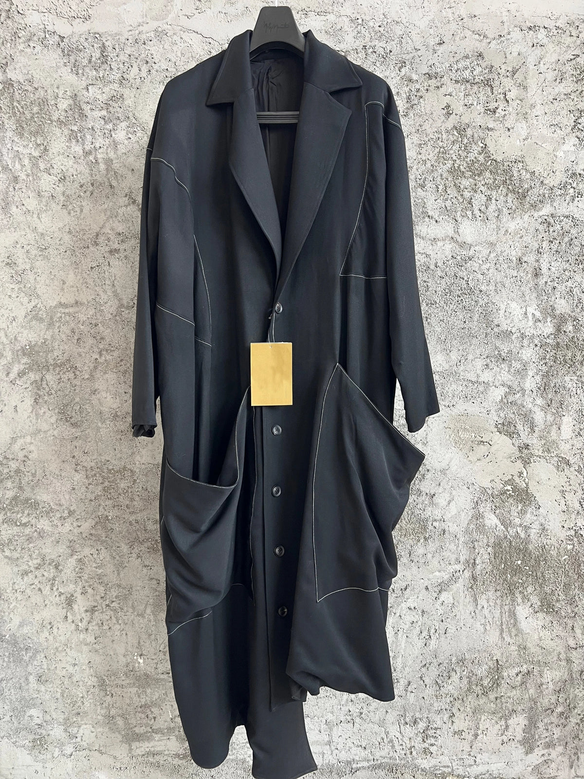 TOP-YAMAMOTO, a niche designer of mid-length trench coats made of pure wool with fringed edges